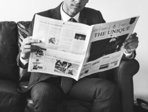 Businessman sitting and reading newspaper